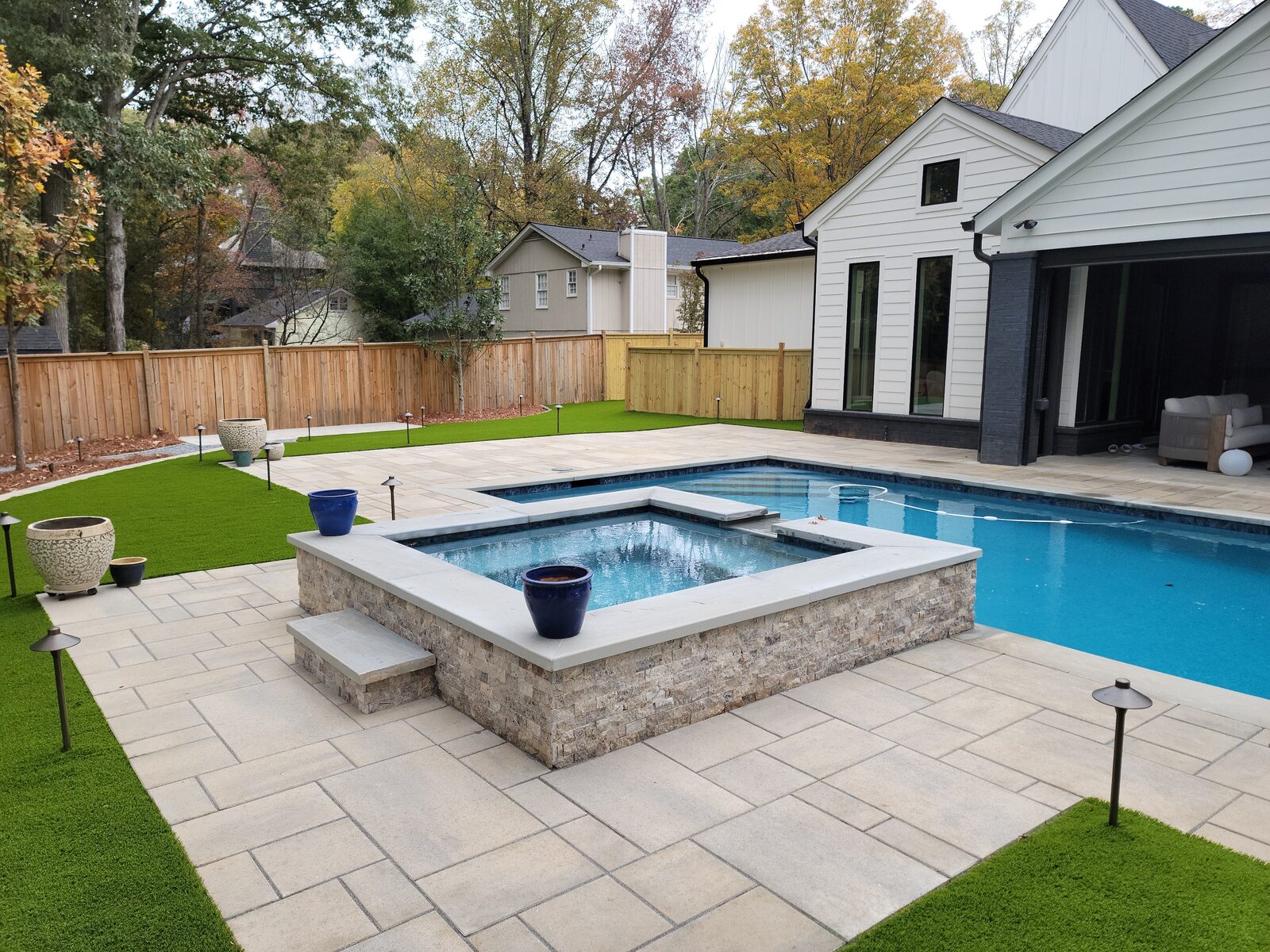 Custom in-ground pool with a paver deck and pergola
